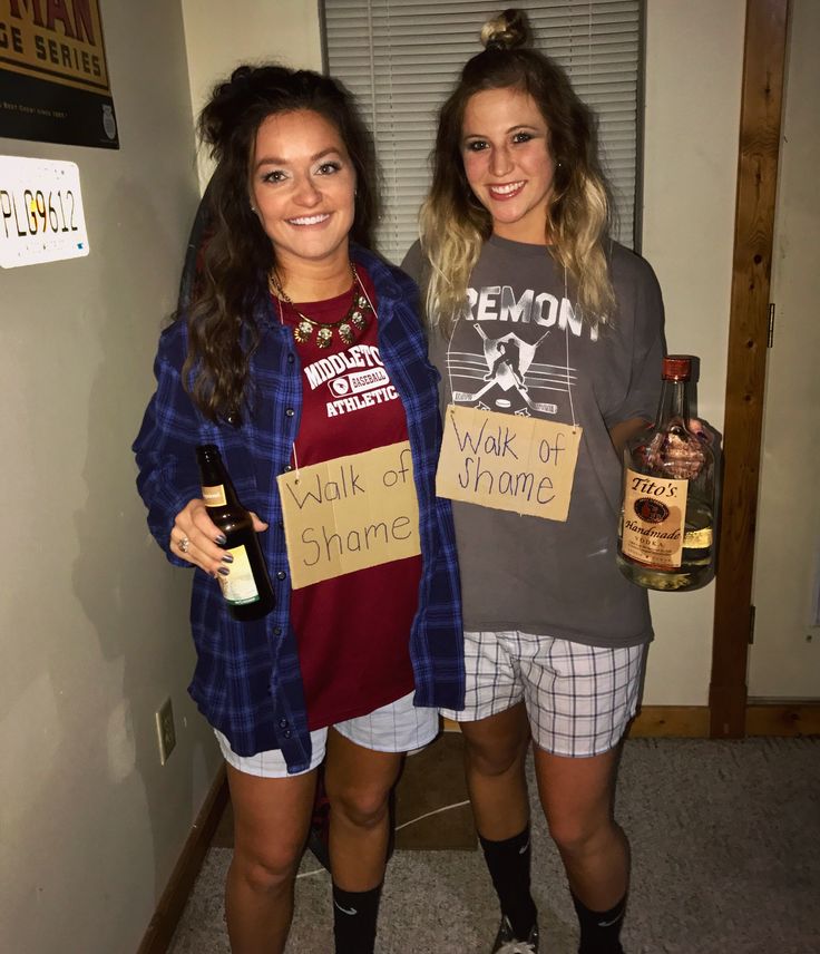 two young women standing next to each other holding bottles of wine and liquor in their hands