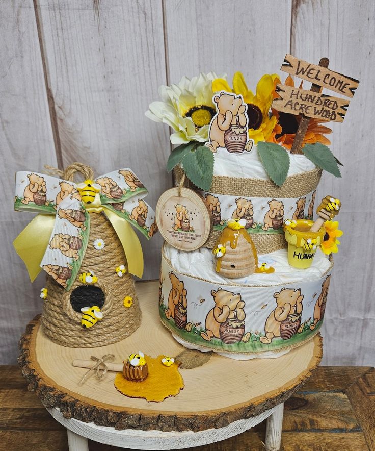 there is a three tiered cake with sunflowers on the top and bees around it