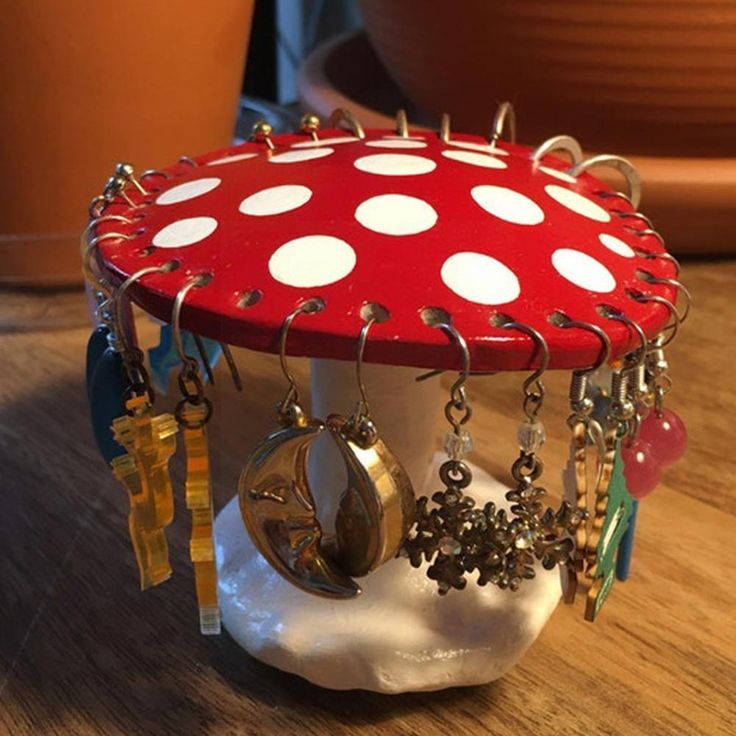 a red mushroom with white polka dots and lots of jewelry hanging from it's sides