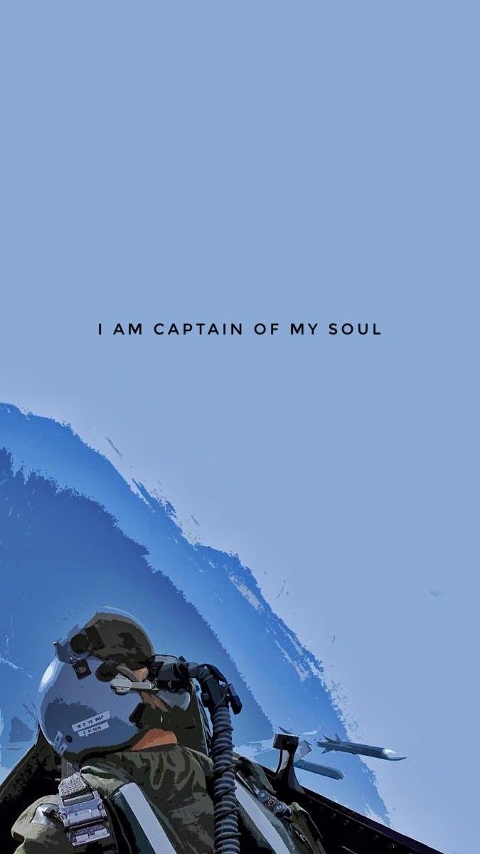 a man sitting on top of a snow covered ski slope next to the words i am captain of my soul