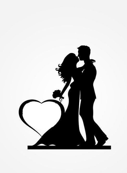 a silhouette of a bride and groom kissing with a heart shaped object in the foreground