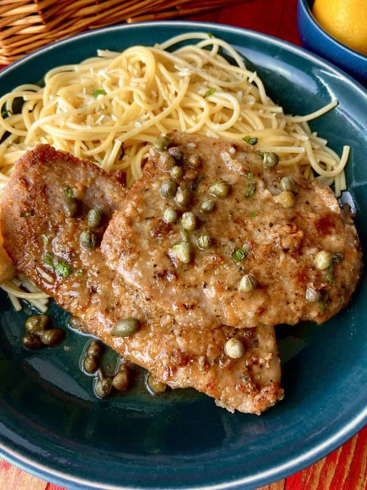 some meat and noodles on a blue plate