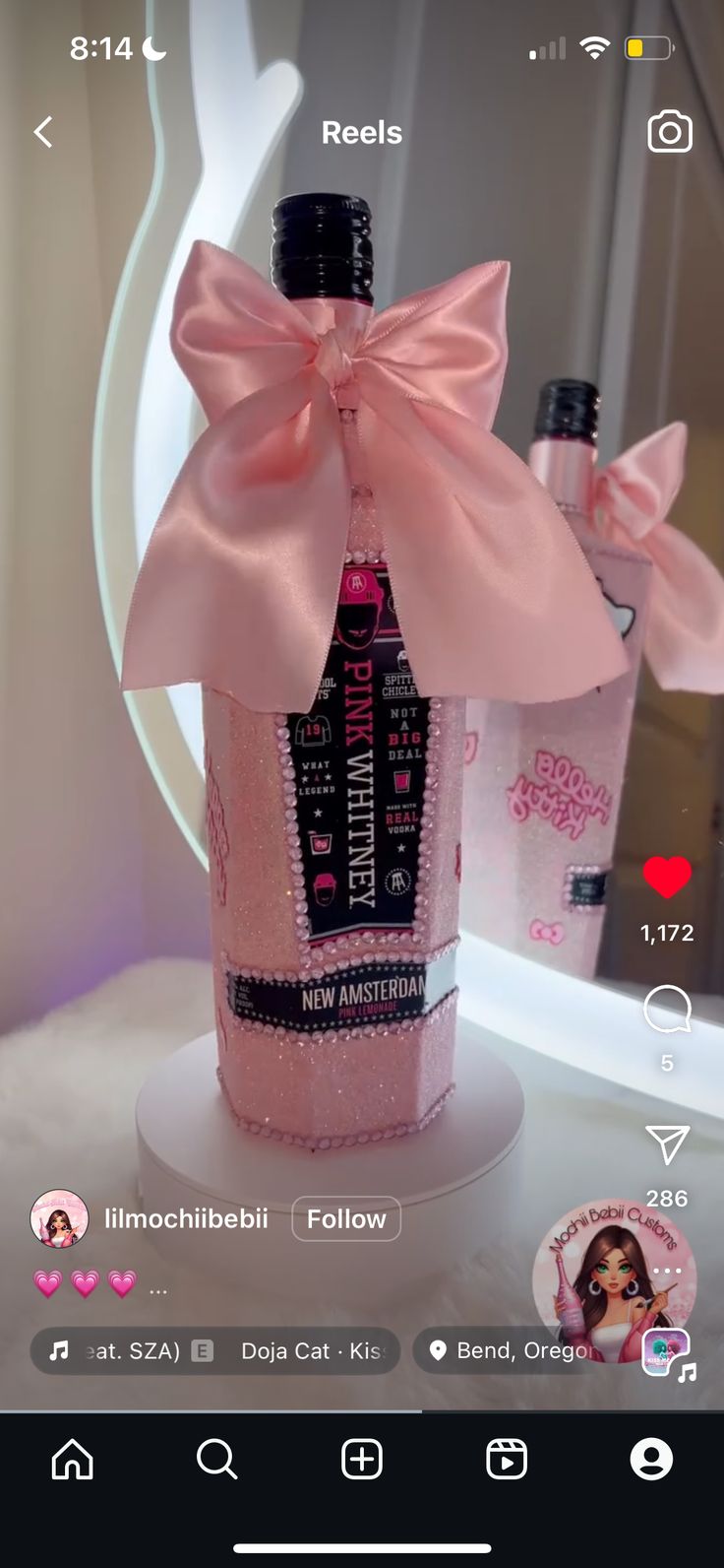 a pink bottle with a bow on it