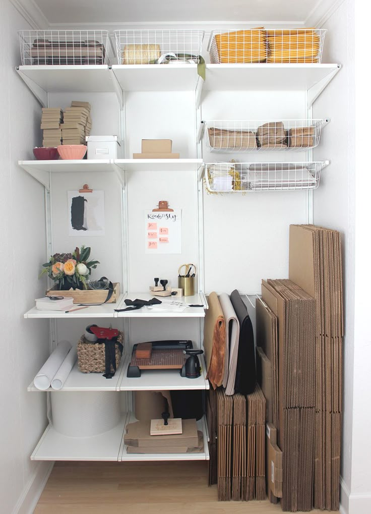 an organized closet with shelves, boxes and other items on the shelf in front of it