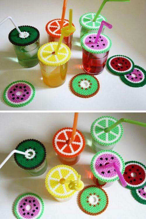 crochet fruit cups with strawberries and oranges on them, one is filled with watermelon