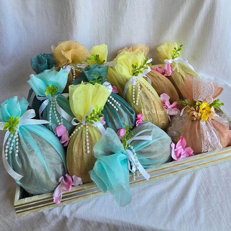 several bags filled with different colored flowers on top of a white sheet