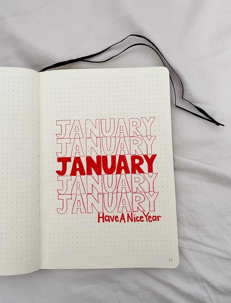 an open notebook with the words january and have a nice year written in red on it