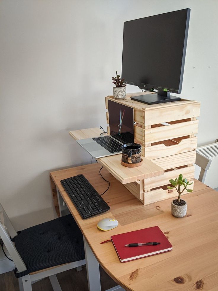 a wooden desk with a computer monitor and keyboard on it