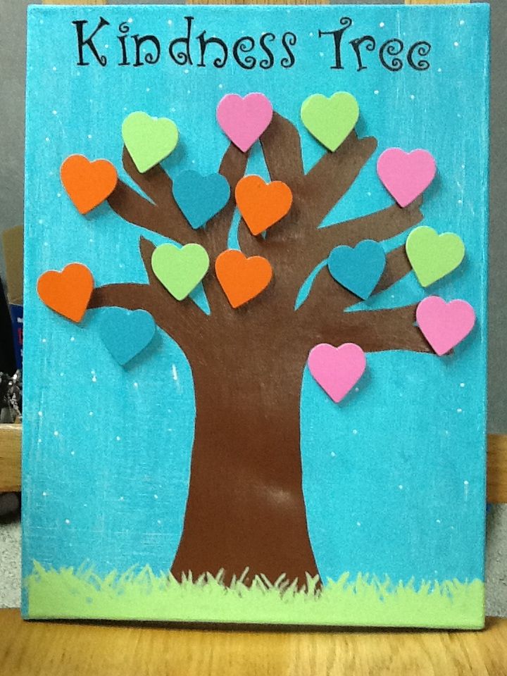 a paper cutout of a tree with hearts on it and the words kindness tree