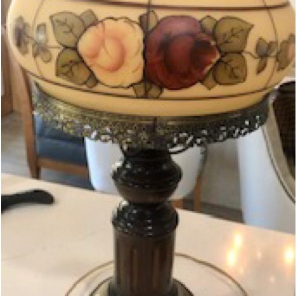 an ornate lamp is sitting on a table