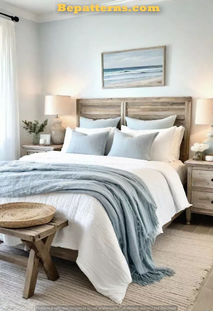 a bedroom with white and blue bedding and pillows