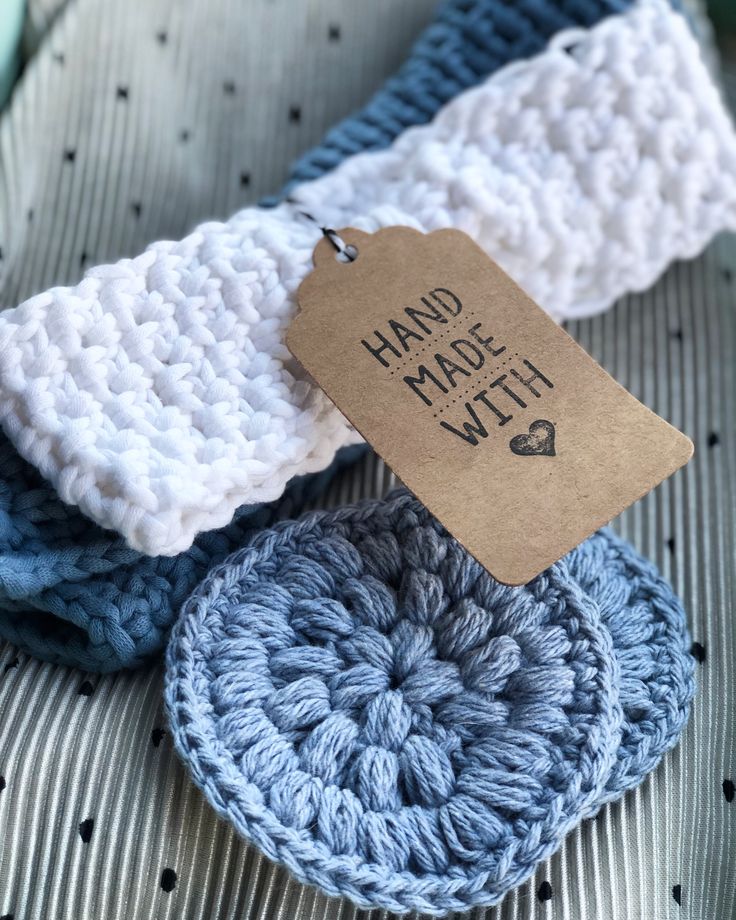 three crocheted items are sitting in a box with a price tag on them