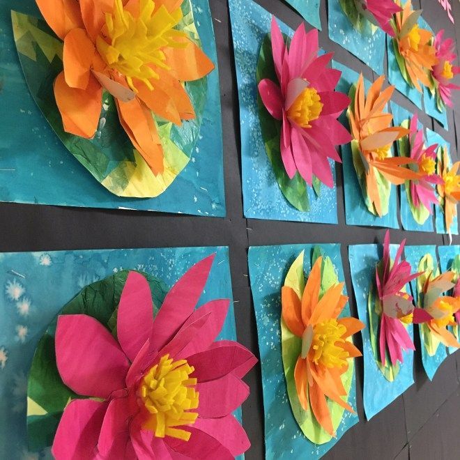 colorful paper flowers are displayed on the wall