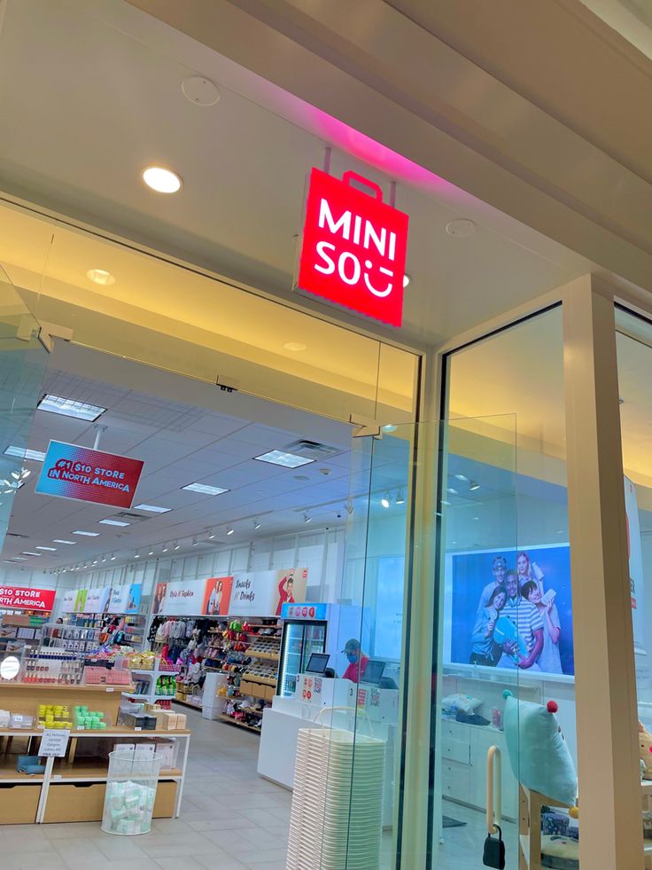 a store front with the words mini sou written on it's glass door