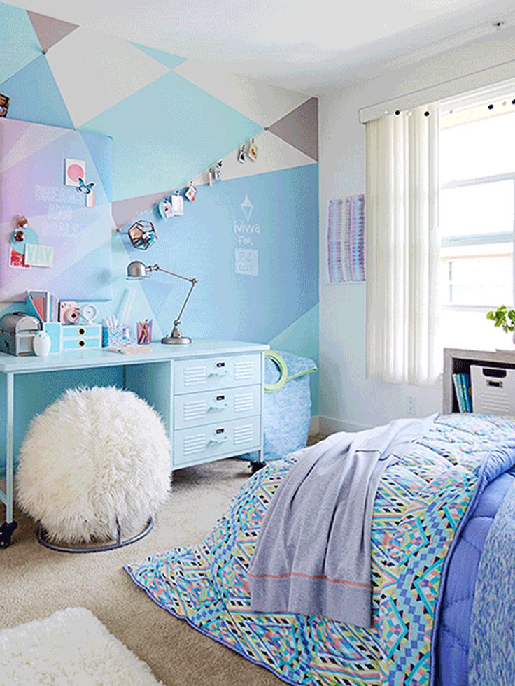 a child's bedroom decorated in pastel blue and pink with geometric wallpaper