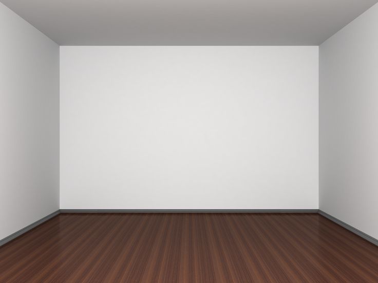 an empty room with wood floors and white walls