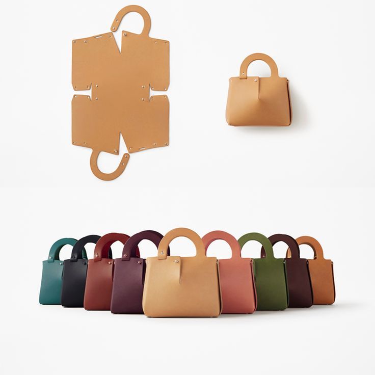 several purses are lined up next to each other on a white background with a puzzle piece hanging from the wall