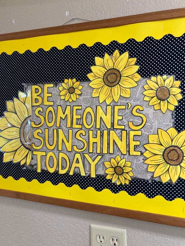 sunflowers are painted on the side of a yellow and black striped sign that says, be someone's sunshine today