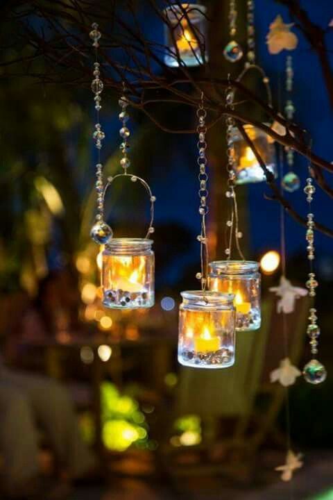 some lights hanging from a tree with words written in english and arabic on the bottom