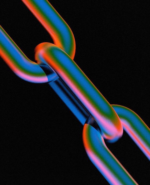 a close up view of a chain that is colored in different colors and shapes on a black background