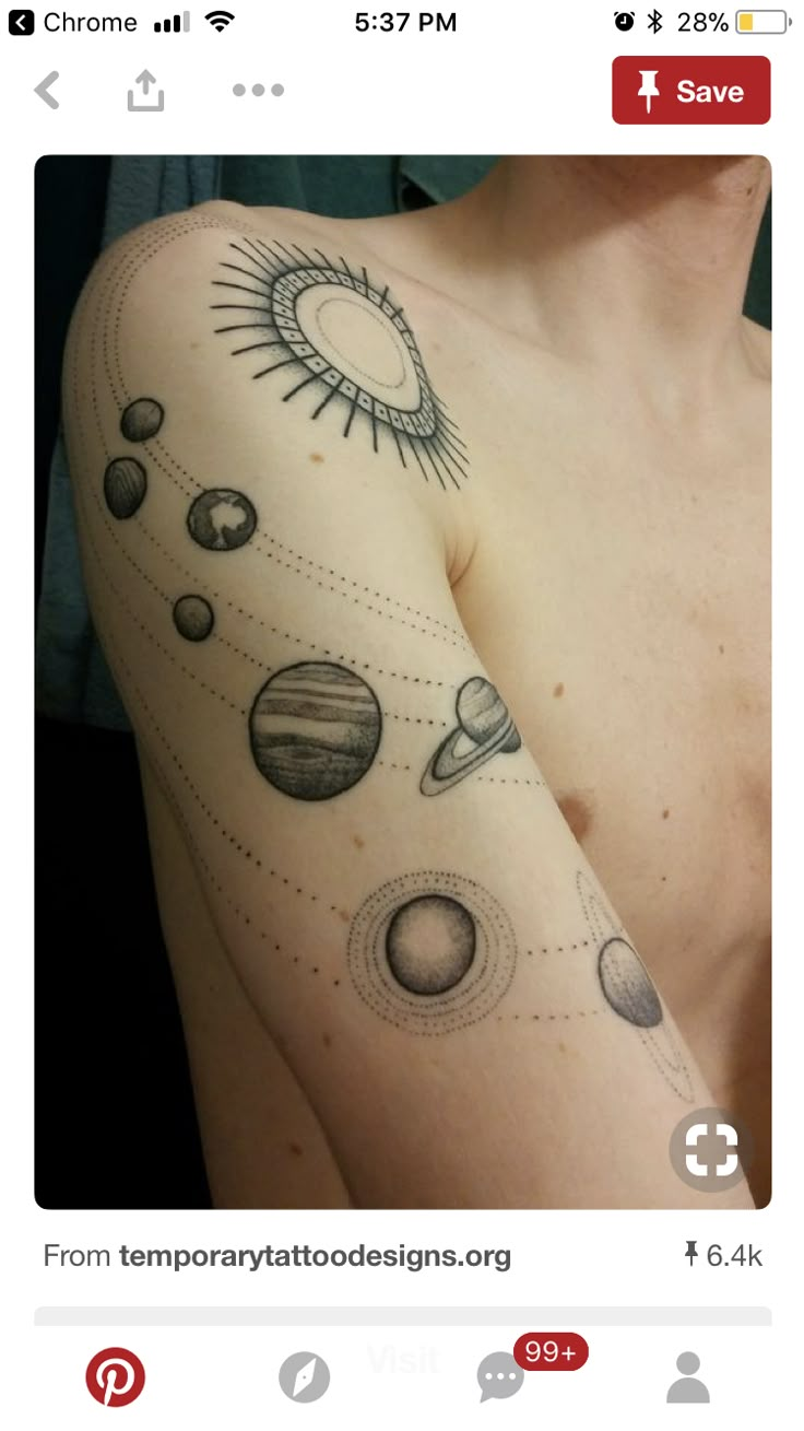 a man with tattoos on his arm that has planets and sun in the sky above it