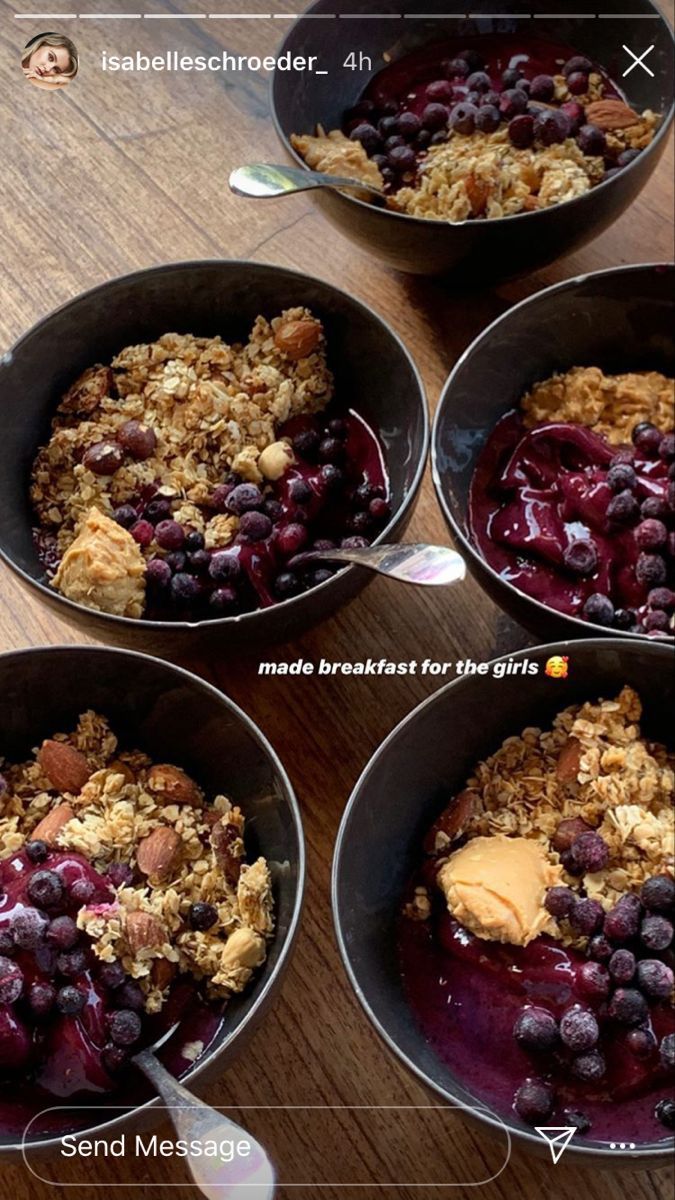 four pans filled with oatmeal and fruit on top of a wooden table