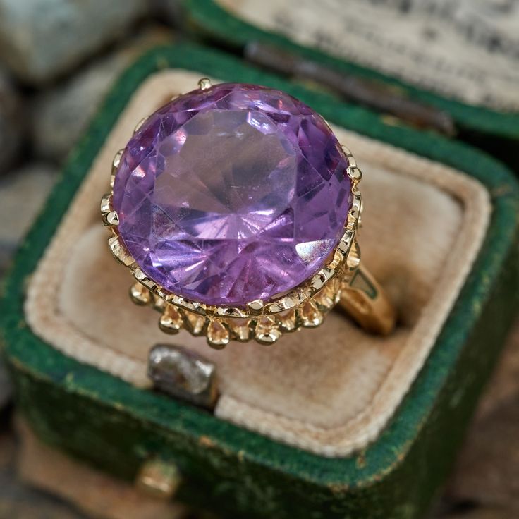 This amethyst cocktail ring features a round cut amethyst in an ornate four prong setting. It is crafted in 14k yellow gold and currently sized to a 5.5. The amethyst shows light wear but it does not distract from the beauty. Luxury Multicolor Amethyst Ring Fine Jewelry, Classic Luxury Multi-stone Amethyst Ring, Luxury Cabochon Amethyst Ring, Luxury Purple Round Stone Jewelry, Light Amethyst Ring, Luxury Unique Amethyst Ring With Accent Stones, Victorian Amethyst Ring In Yellow Gold, Formal 14k Gold Amethyst Ring, Purple 14k Gold Rings With Brilliant Cut