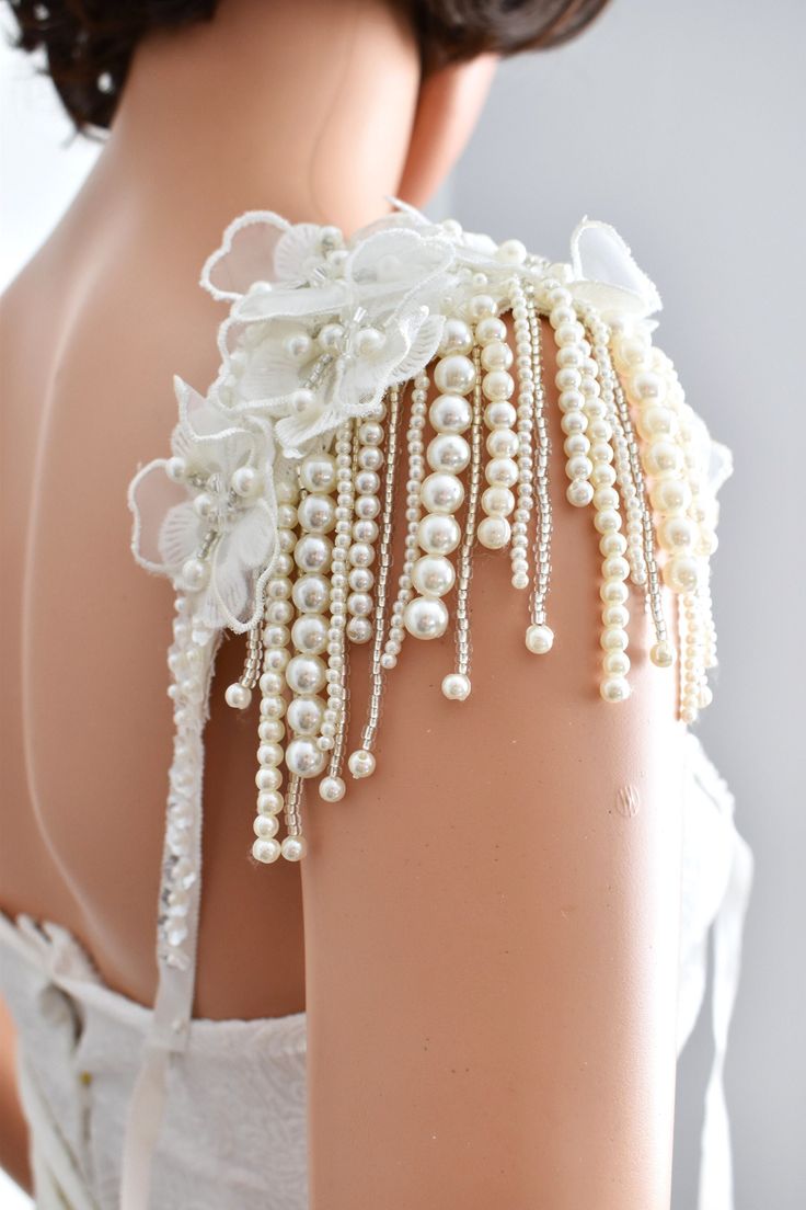 Bridal shoulder epaulette embellished with off-white lace and  pearls and glass beads with pearl tassel You can use it both in your wedding dress and on the shoulder of your evening dress. You can order the epaulette with pin or ribbon. There is a transparent sequin and pearl detail on the ribbon. If you chose the ribbon option, please let me know the size of the ribbon Lace size:  9 inch  lenght  x  3 inch     ( 23cm x 8cm )  Pearl tassel lenght:  3.5 inch  ( 9 cm ) ♥Thank you for supporting ha Diy Pearl Dress, Dress With Beads Design, Beaded Pearl Dress, Wedding Shoulder Jewelry, Fitted Bridal Accessories With Pearl Embroidery For Wedding, Pearl Embroidery Dress, Pearl Dress Design, Fitted White Bridal Accessories With Pearl Embroidery, Bridal White Accessories With Pearl Embroidery