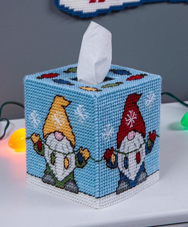 a tissue dispenser sitting on top of a table next to a christmas ornament