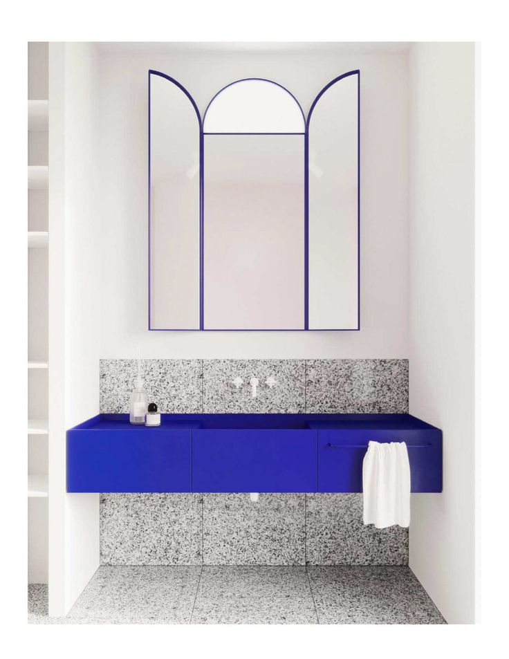 a bathroom with a blue sink and mirror on the wall, along with shelving units