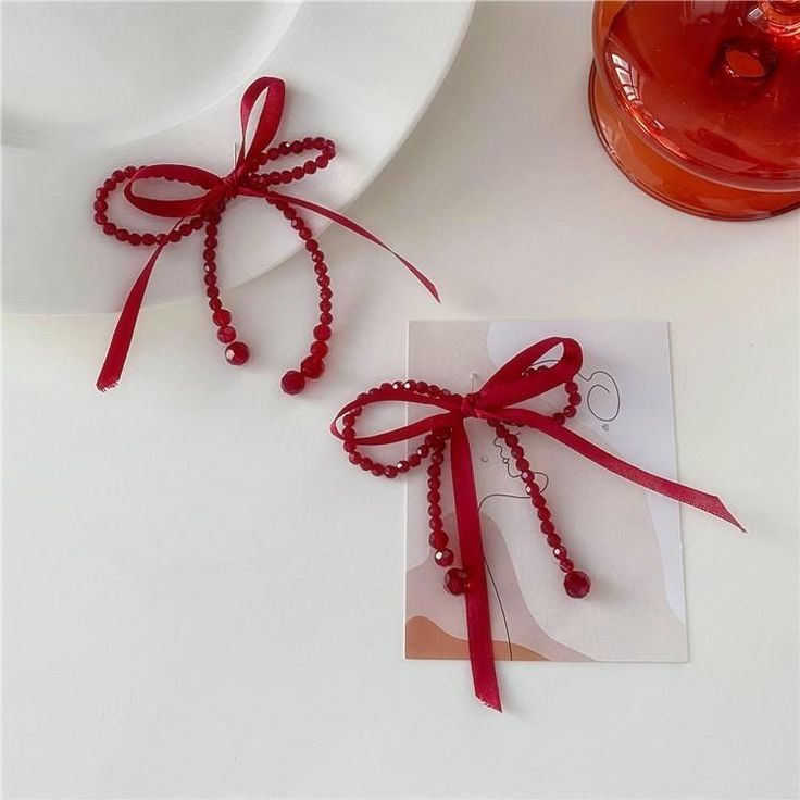 two red beads tied together on a white plate