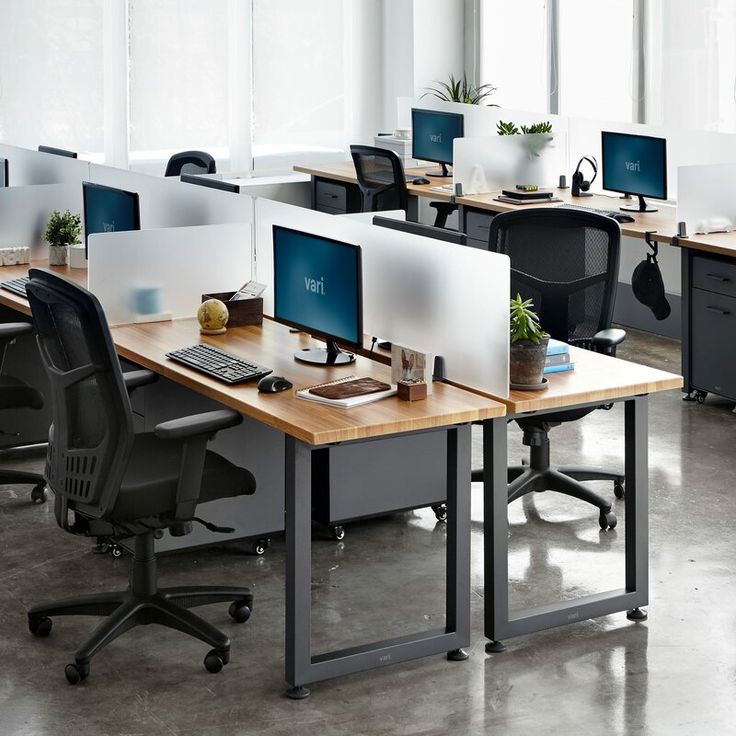 an office with multiple desks and computers