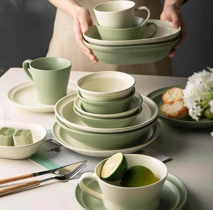 a table set with plates, cups and utensils