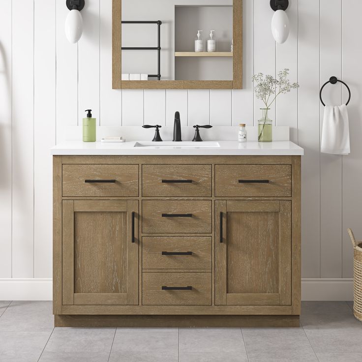 a bathroom vanity with two sinks and mirrors