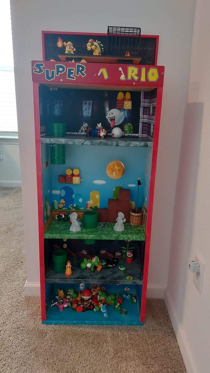 a toy vending machine in the shape of a super mario bros display case with toys on it