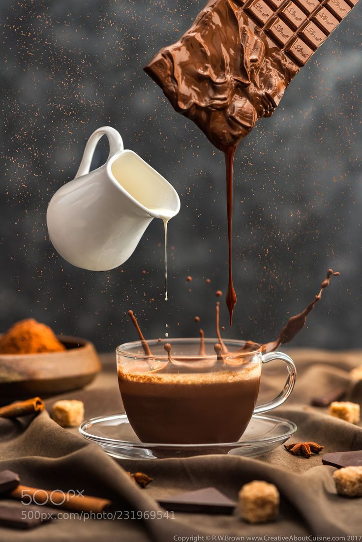 chocolate being poured into a cup with marshmallows