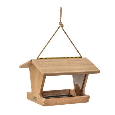 a wooden bird feeder hanging from a rope