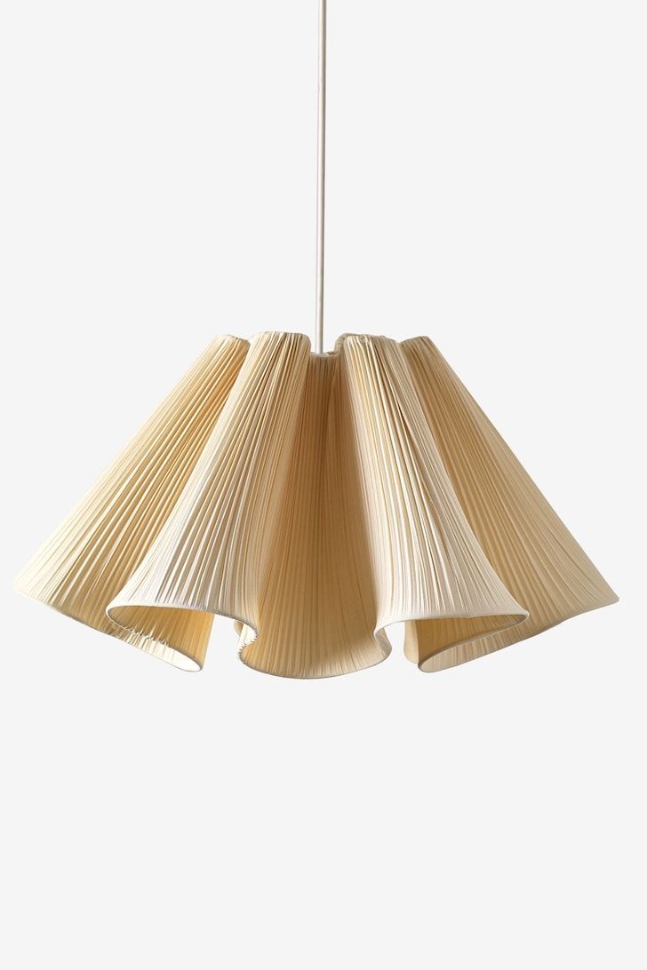 a light that is made out of pleated paper and hanging from a ceiling fixture