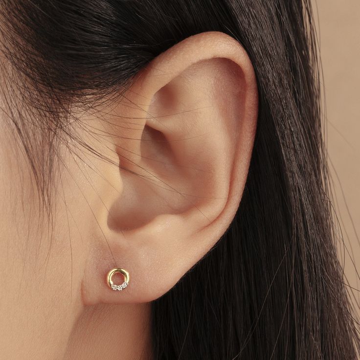 Want in on the minimalist earring trend, but upgraded with diamonds? We have just what you need with our Open Circle Diamond Studs - chic and simple and studded with six little diamonds. Product Details: Material: 14K Solid Yellow Gold Outer Diameter: 5.0mm Thickness: 1.2mm Total Carat Weight: 0.03carat Sold as a pair Gold Earrings Studs Simple, Small Earrings Gold, Gold Earrings Indian, Simple Gold Earrings, Minimalist Earring, Gold Earrings Models, Fancy Jewelry Necklace, Minimalist Earrings Gold, Pretty Jewelry Necklaces