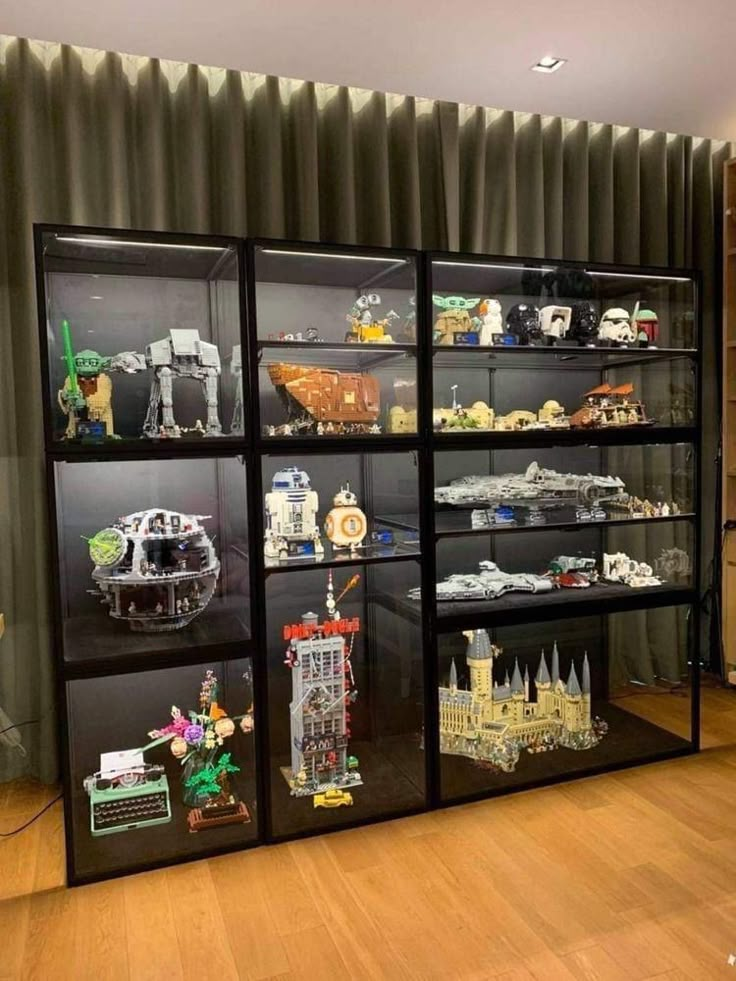 the display case is filled with legos and other toy items, including star wars vehicles