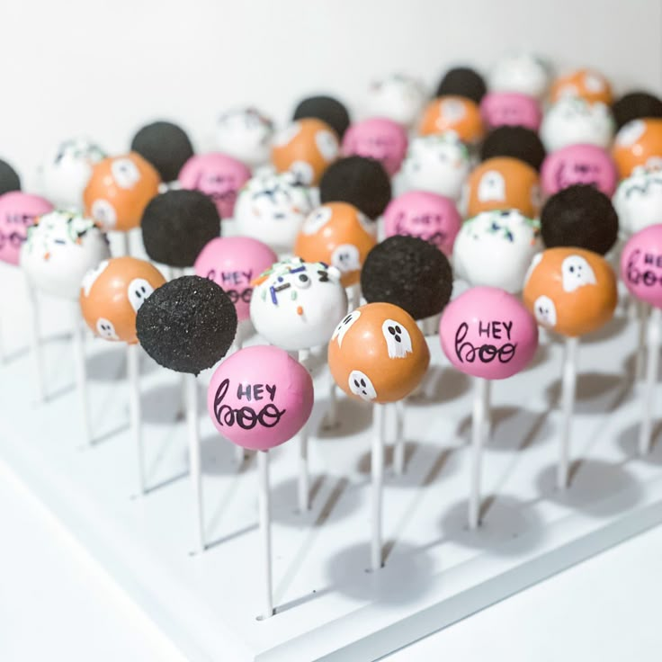 there are many cake pops with different designs on them