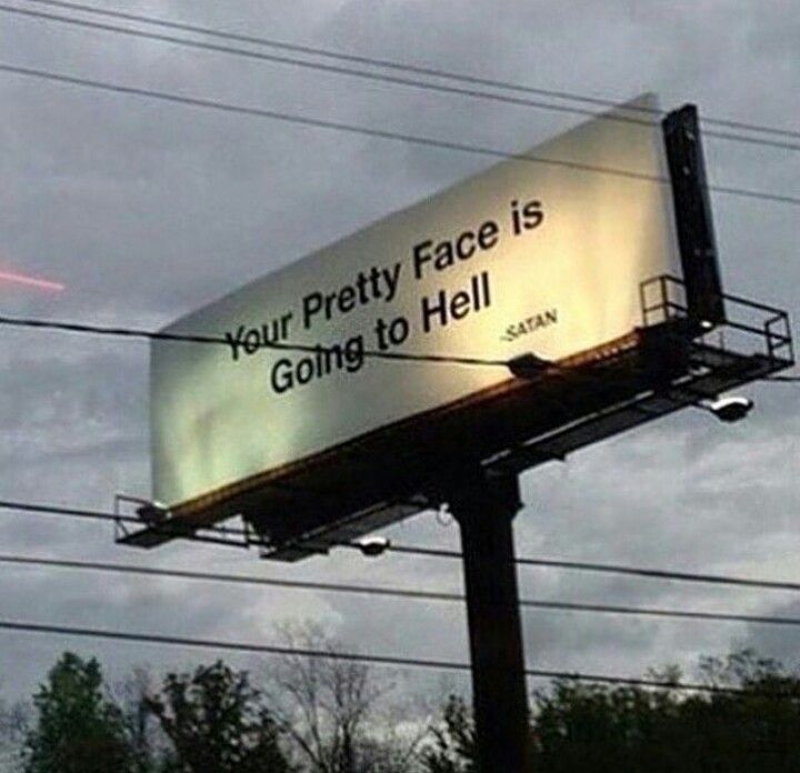 a billboard on the side of a pole that says your pretty face is going to hell