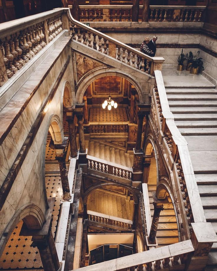 an aerial view of the inside of a building with many stairs and railings in it