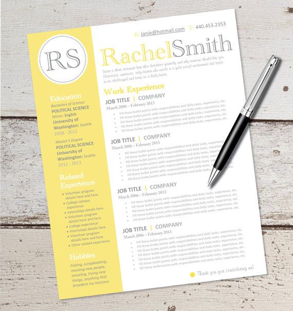 a yellow and white resume with a pen next to it on top of a wooden table