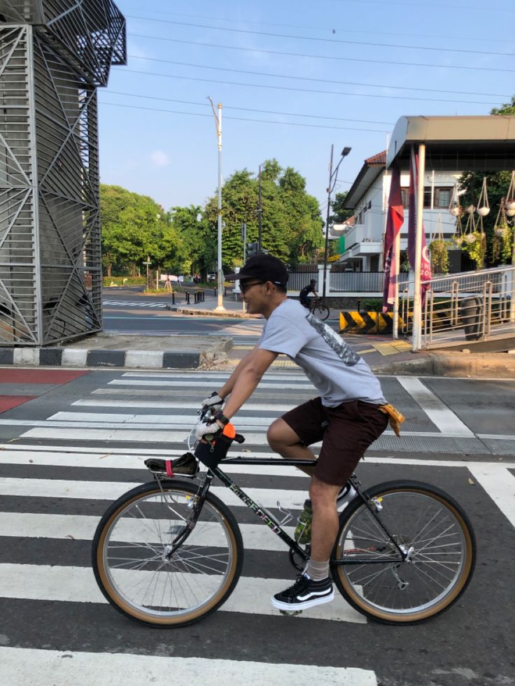 a man riding a bike across a cross walk