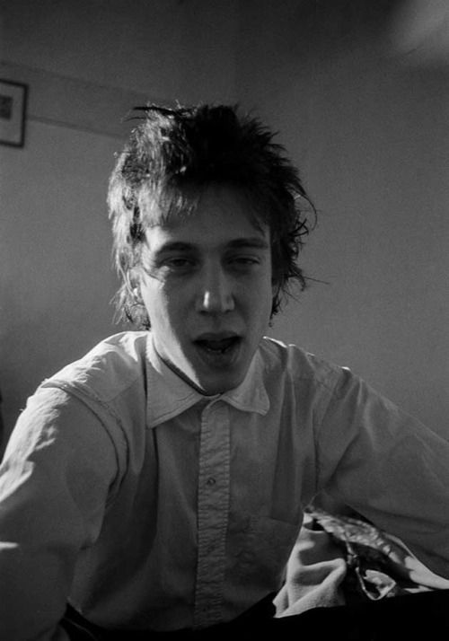 black and white photograph of a young man in shirt and tie making a surprised face