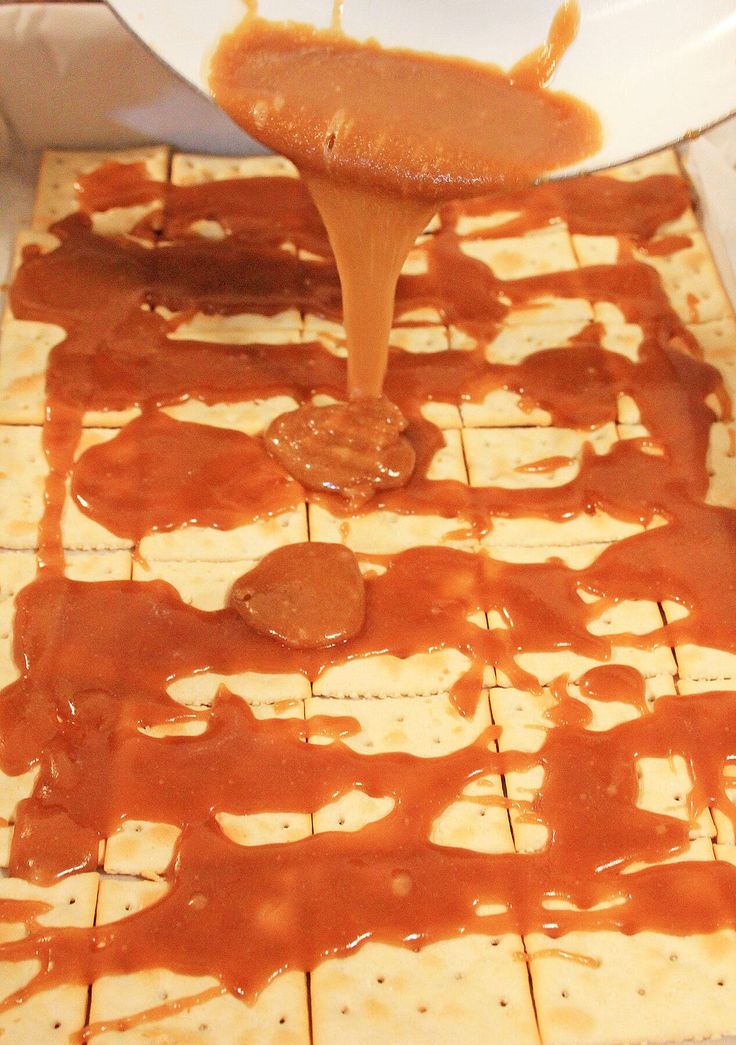 someone is pouring caramel sauce on some flat bread