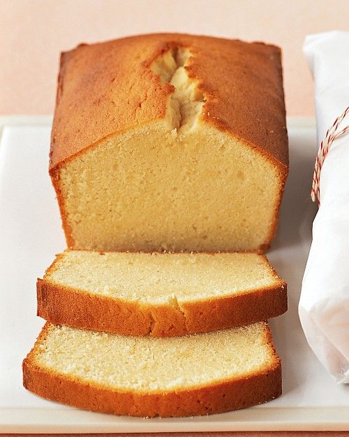 a loaf of pound cake sitting on top of a white plate next to a candy cane