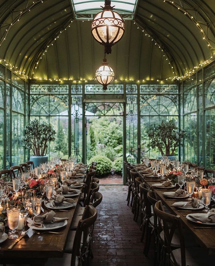 an indoor dining area with tables and chairs set up for formal dinner in the sun room