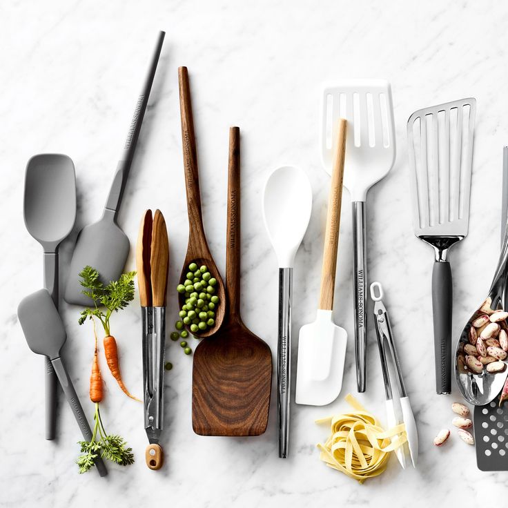 the kitchen utensils are laid out on the counter top, with various ingredients in them